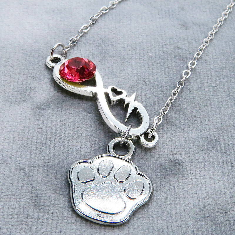 シルバーカラー クリスタル(マゼンタ)のエターニティーと肉球モチーフを組合せたネックレス ステンレス可 長さ調整可拍卖