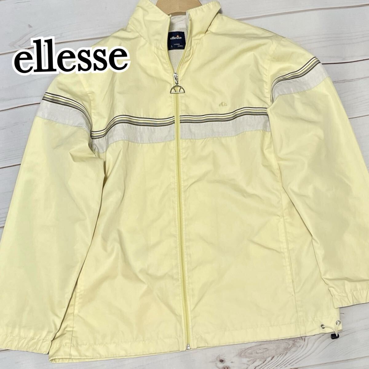 ellesse エレッセ ナイロンジャケット 切替デザイン ラグラン裏地メッシュ ドロスト イエロー Lサイズ L レディース スポーツ アウトドア拍卖
