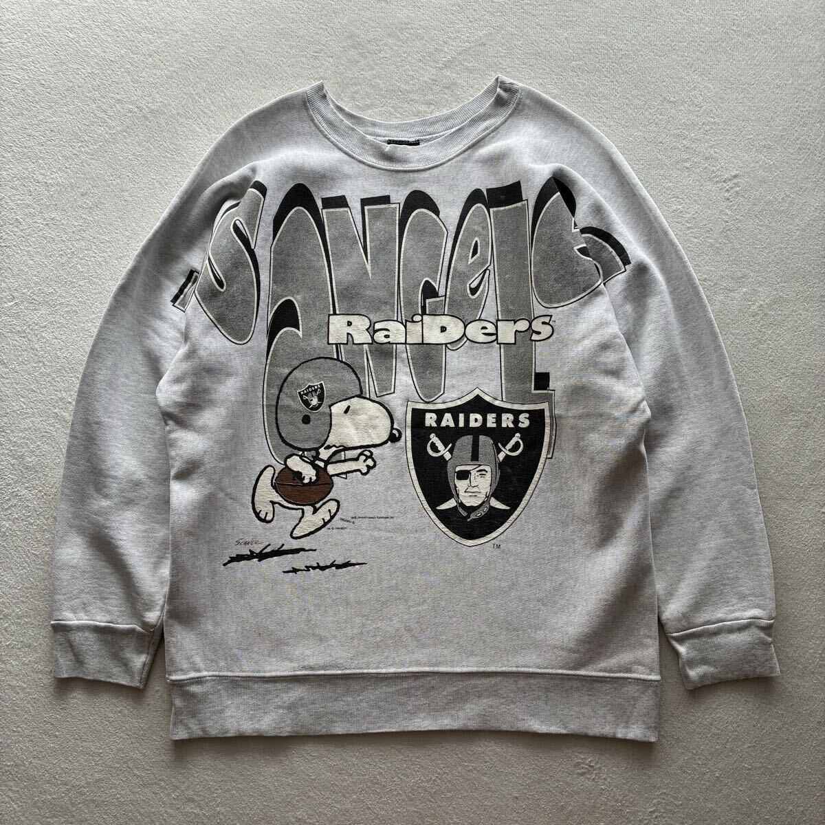 【希少】90s ガーメントグラフィックス ロサンゼルスレイダース ピーナッツ スヌーピー 大判プリント L グレー 古着 USA製 アメリカ製拍卖