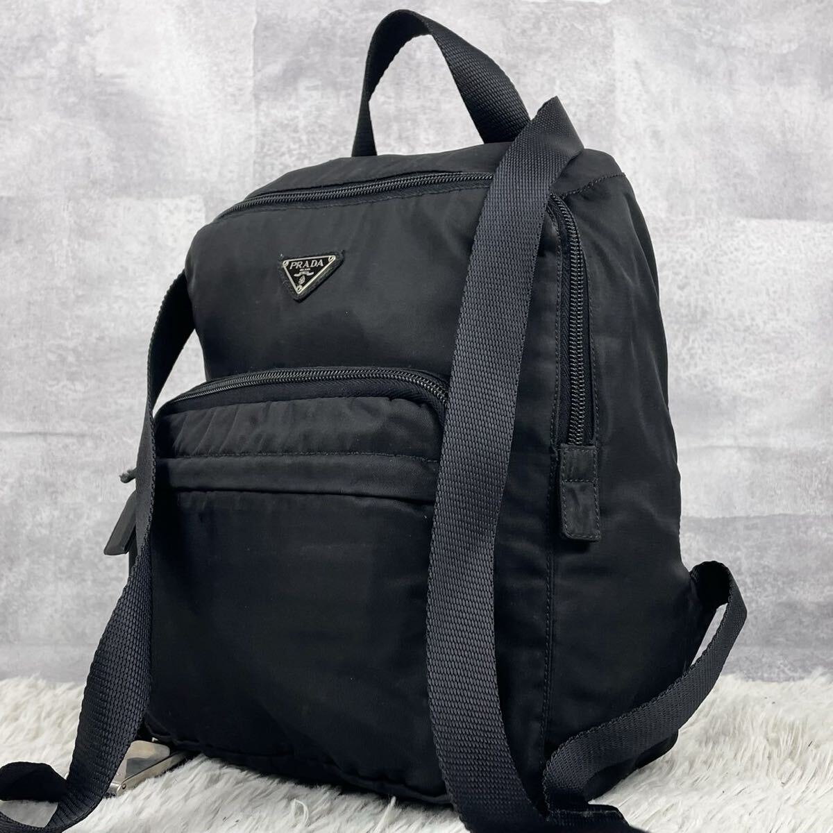 超希少品 PRADA プラダ バックパック リュック ハンド 通勤 書類 メンズ ナイロン レザー フラップ 3角プレート ロゴ型押し ベルト 黒拍卖