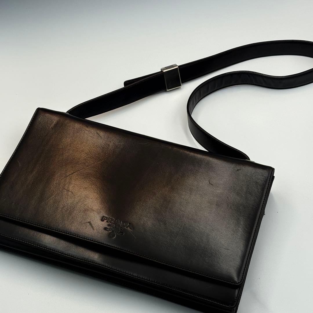 美品PRADAレザーショルダーバッグ ロゴ型押ダークブラウンベルトバックル脱着拍卖