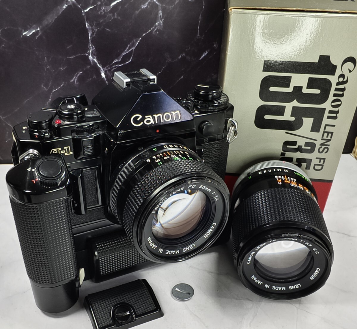【終活整理】Canon A-1+NEW FD 50mm f1.4+FD 135mm f3.5 単焦点2本+強力モータードライブMAセット 各動作良好 露出計OK 持病鳴きなし 拍卖