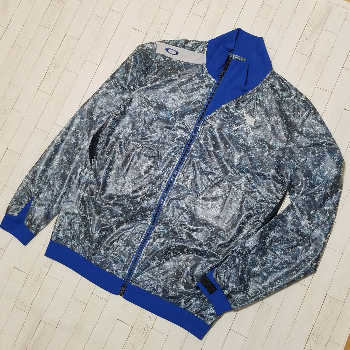 【極美品】◎ OAKLEY オークリー/ 長袖 刺繍ロゴ & 刺繍スカルロゴ ダブルジップ カモフラ柄 ウィンドジャケット(薄手) SIZE: M ブルー拍卖