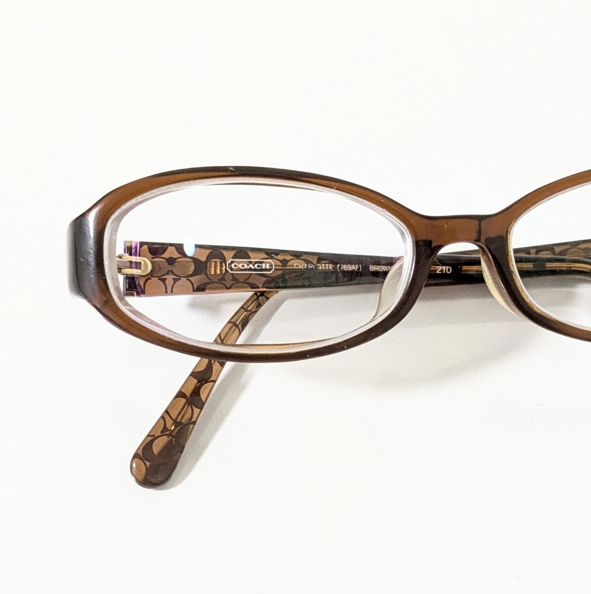 《 COACH 》コーチ 度入り眼鏡　シグネチャー クリアブラウンのセルフレーム　オーバル型　芯金ロゴ入り　レディースメガネ　CHARLOTTE　