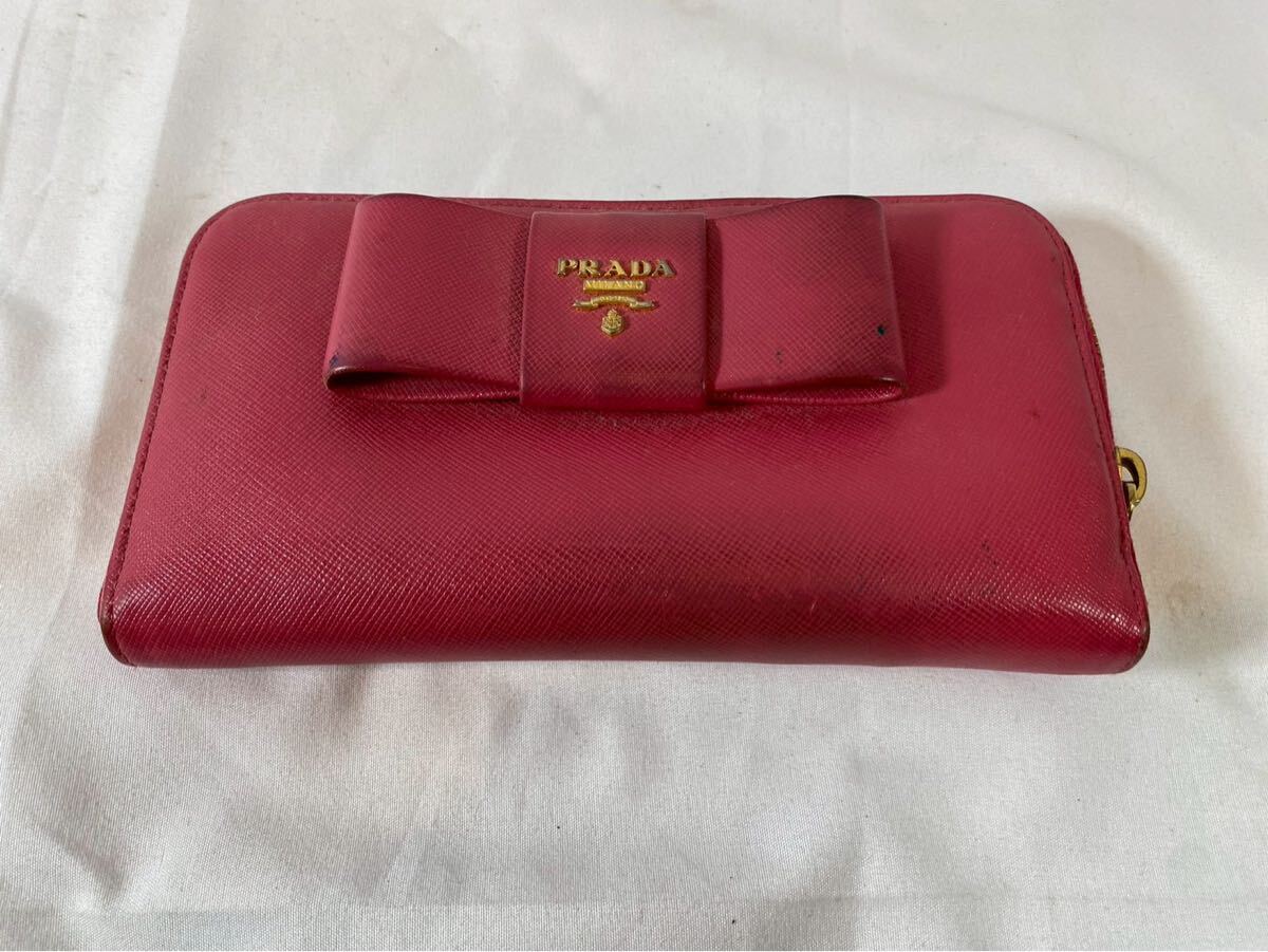 ③ PRADA プラダ リボン レザー レッド サフィアーノ ラウンドジップ 財布　【04011】