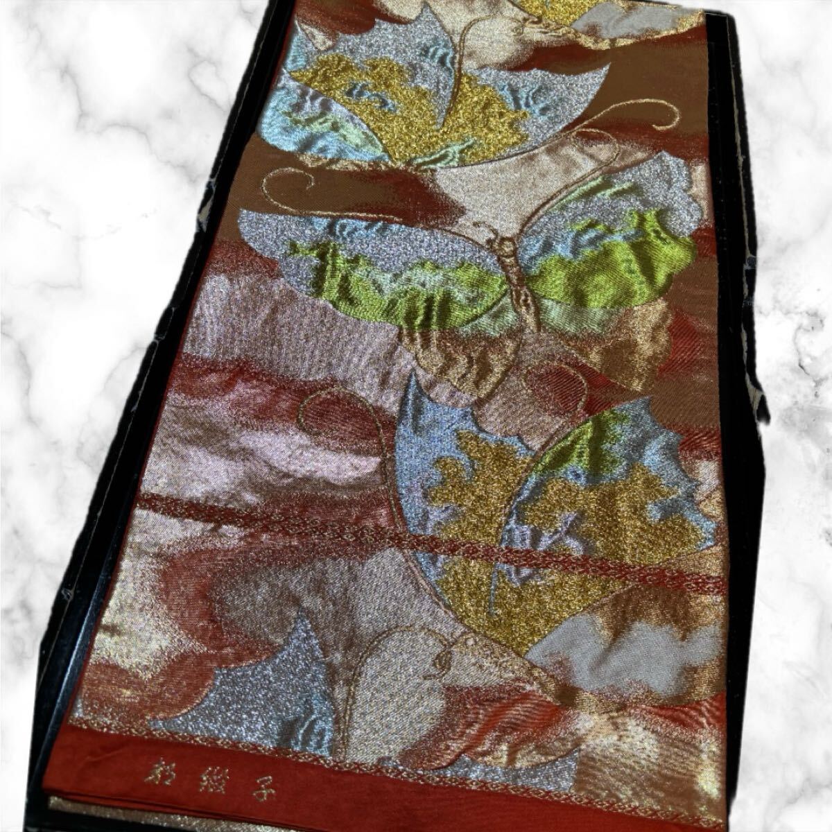袋帯　正絹　都緞子　膨れ織　蝶　雲　暈　六通柄　橙色　着物　和服　和装　リメイク　ハンドメイド　生地　衣装　百貨店　高級