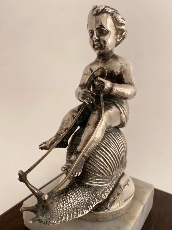 Cupid sitting astride a snail's shell,1920s silvered bronze FRANCE.カタツムリに乗った天使　非常に珍しいマスコットです。