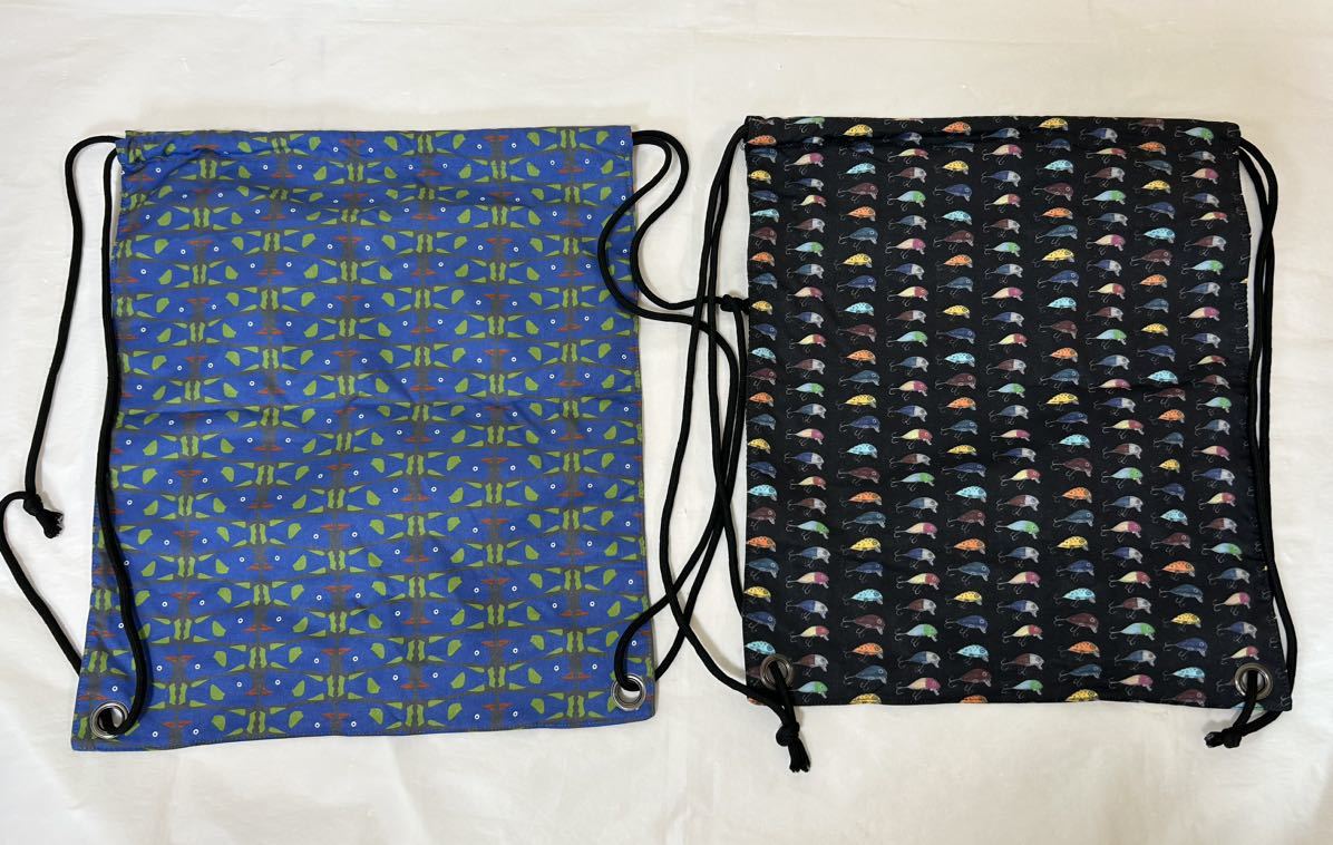 J032 未使用保管品 gym master ジムマスター ハッピーペイント ナップザック アウトドア まとめて2点 コブダイ柄 ルアー柄 リュック 青 黒