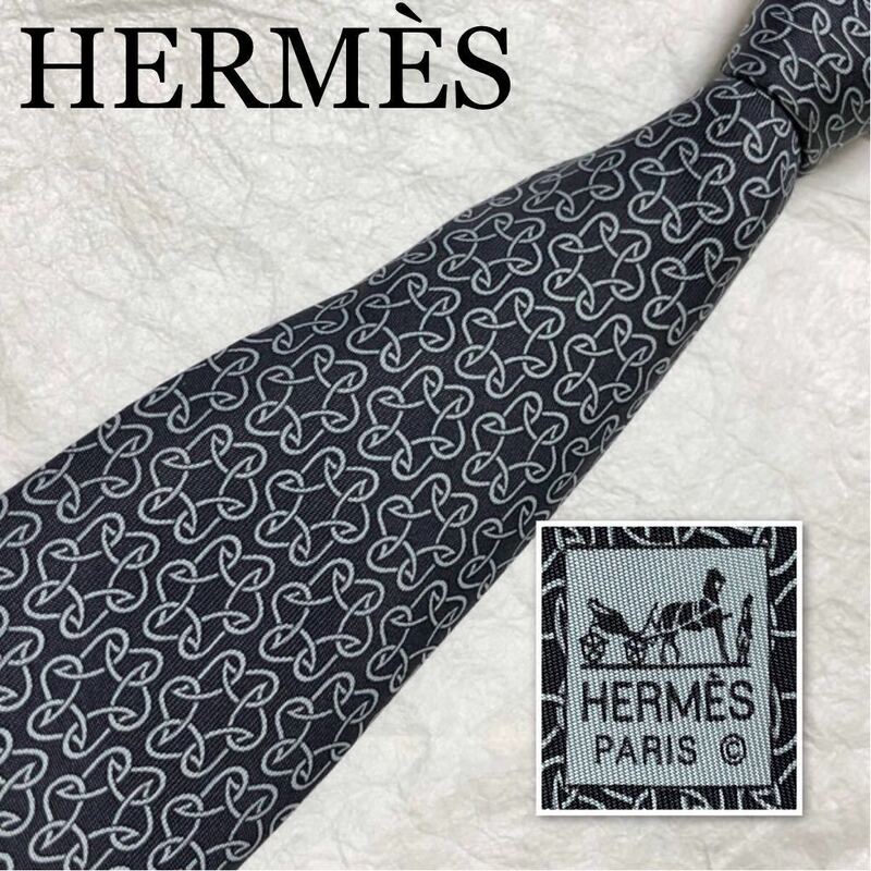 ■美品■HERMES エルメス　ネクタイ　金具　総柄　シルク100% フランス製　ブラック×グレー
