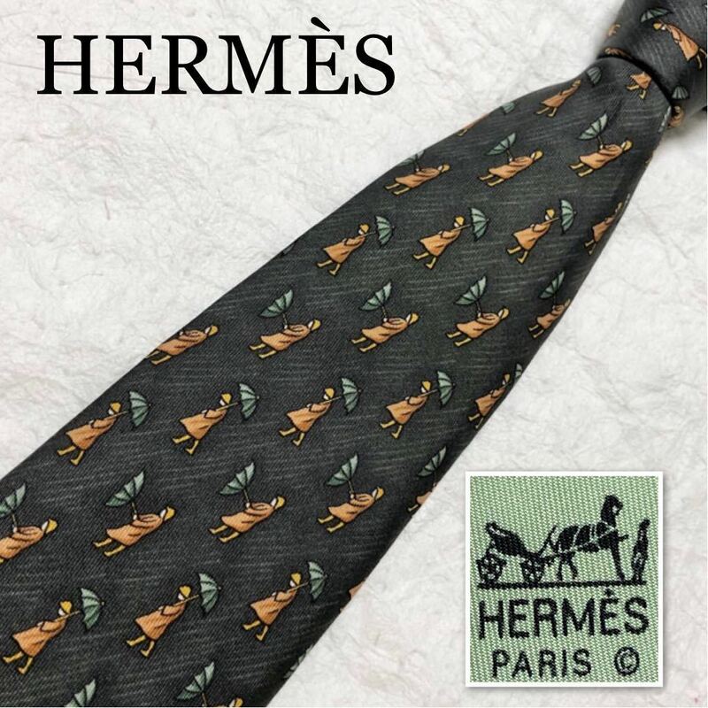 ■美品■希少デザイン■HERMES エルメス　ネクタイ　カッパを着て傘をさす人　雨　総柄　シルク100% フランス製　ダークグリーン