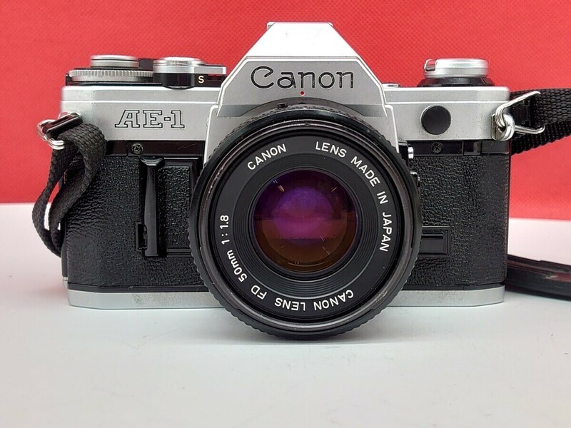 ▼ Canon AE-1 ボディ LENS NEW FD 50㎜ F1.8 レンズ 一眼レフカメラ フィルムカメラ 動作確認済 露出計OK 現状品 キヤノン