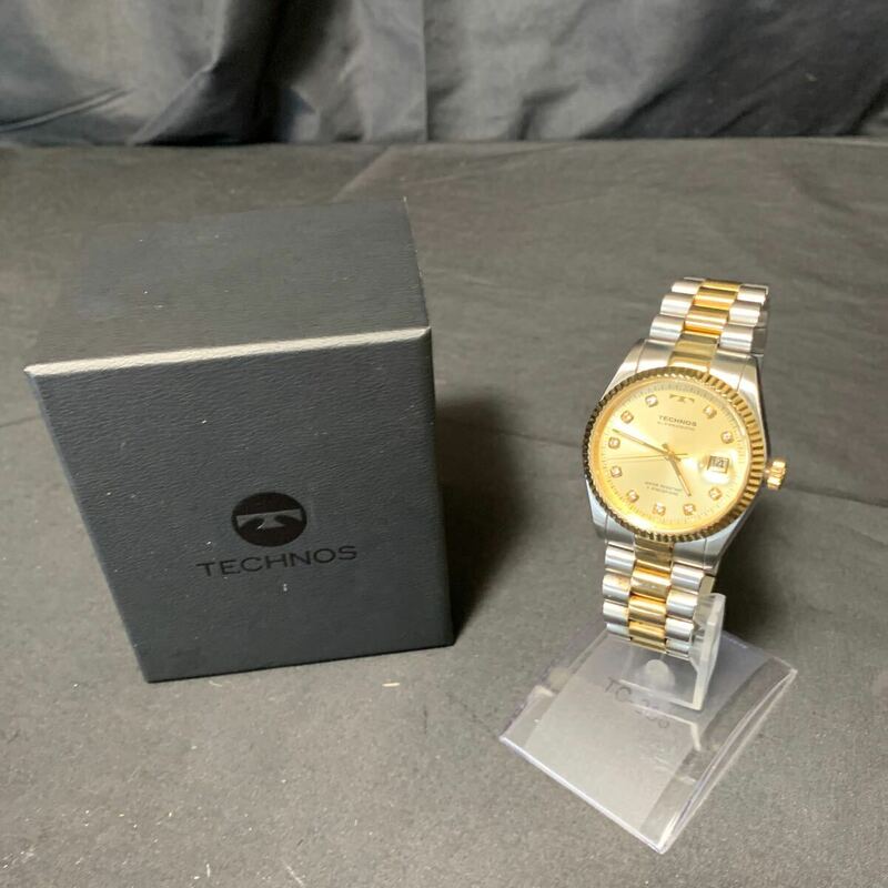 TECHNOS テクノス メンズ 腕時計 T9604 ゴールド×シルバー 文字盤 ゴールド ストーン 箱付き ラウンド 3針 デイト ウォッチ