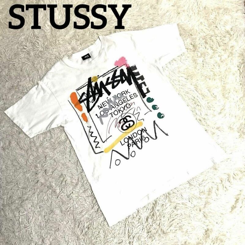 STUSSYステューシー ワールドツアー Tシャツ 半袖 ペイント ロゴ プリント 古着　ホワイト　メンズ M